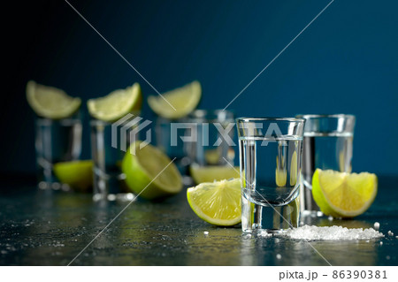 Tequila shots with lime slices and sea salt. Tequila shots with lime slices and sea salt. 86390381