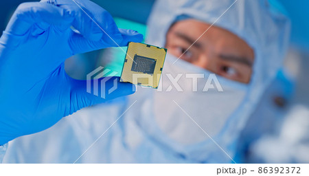 engineer holds microchip 86392372