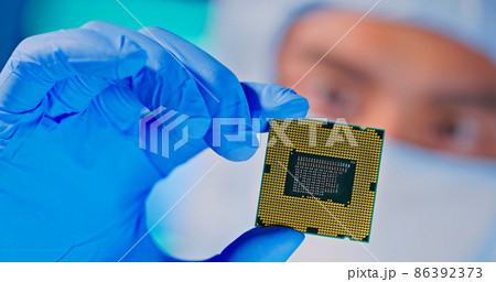 engineer holds microchip 86392373