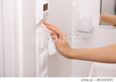 Cleaning switches and sockets with a microfiber cloth. Sanitize surfaces prevention in hospital and public spaces against corona virus. Woman hand using wet wipe for cleaning home room door link. Cleaning switches and sockets with a microfiber cloth. Sanitize surfaces prevention in hospital and public spaces against corona virus. Woman hand using wet wipe for cleaning home room door link. 86392695