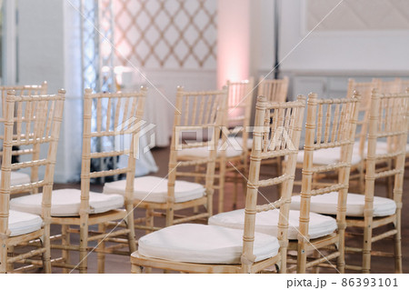 A place for a wedding ceremony in the interior with chairs. Decorated wedding venue 86393101