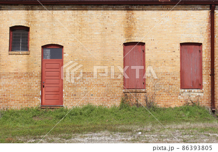 Close-up Building Detail Historical Brick Wall With Doors and Windows Close-up Building Detail Historical Brick Wall With Doors and Windows 86393805