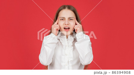 pondering kid in white shirt on red background. childhood. thinking child portrait. cognition 86394908