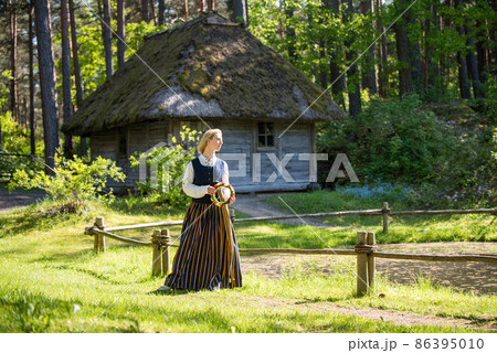 Latvian woman in traditional clothing. Ligo folk. Latvian woman in traditional clothing. Ligo folk. 86395010
