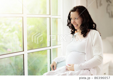 Pregnant woman at home. Young expecting mother. Pregnant woman at home. Young expecting mother. 86396057