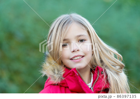 Girl with blond long hair smile on natural environment Girl with blond long hair smile on natural environment 86397135