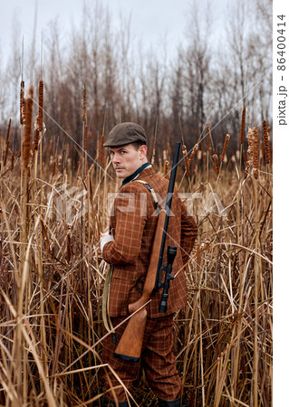 outdoor hunting on wild animals at autumn season. Man holding shotgun. on hunt outdoor hunting on wild animals at autumn season. Man holding shotgun. on hunt 86400414
