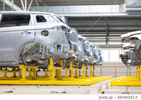 Photo of automobile production line. Welding car body. Modern car assembly plant. Auto industry Photo of automobile production line. Welding car body. Modern car assembly plant. Auto industry 86400913
