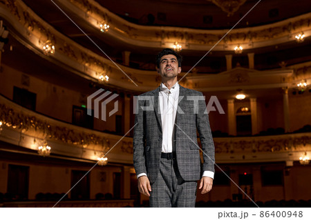 Showman. Young male entertainer, presenter or actor on stage. male public speaker 86400948