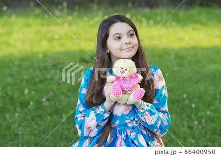 Girl kid hug soft toy teddy bear love symbol, kindness and charity concept Girl kid hug soft toy teddy bear love symbol, kindness and charity concept 86400950