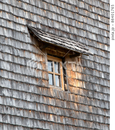 Antique window in a wooden planked wall, close-up. Exterior Antique window in a wooden planked wall, close-up. Exterior 86401765
