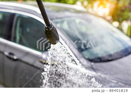 Car wash with modern car shampoo using a high pressure washer in summer. Background, cleaning cars from dirt Car wash with modern car shampoo using a high pressure washer in summer. Background, cleaning cars from dirt 86401819