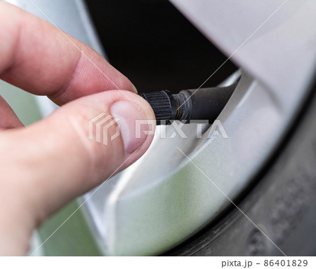 A man spins a wheel valve in a car, close-up A man spins a wheel valve in a car, close-up 86401829