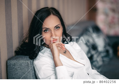 beautiful brunette girl in white shirt at home beautiful brunette girl in white shirt at home 86402256