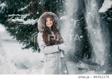 happy young woman in red hat in winter. toned photo happy young woman in red hat in winter. toned photo 86402276