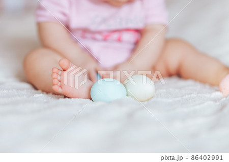 Cute little baby girl, playing with colorful easter eggs 86402991