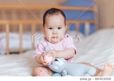 Cute little baby girl, playing with colorful easter eggs 86403000