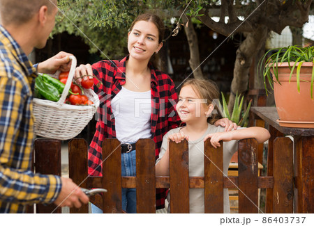 Man offers fresh vegetables to neighbors in country Man offers fresh vegetables to neighbors in country 86403737