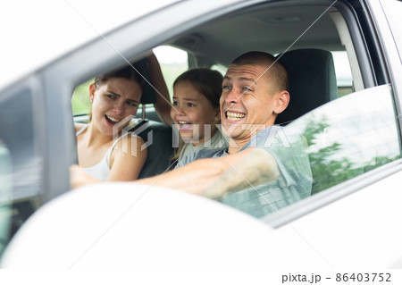 Man driver, his wife and doughter scared screaming in the car Man driver, his wife and doughter scared screaming in the car 86403752