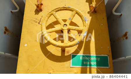 yellow emergency door at a ship 86404441