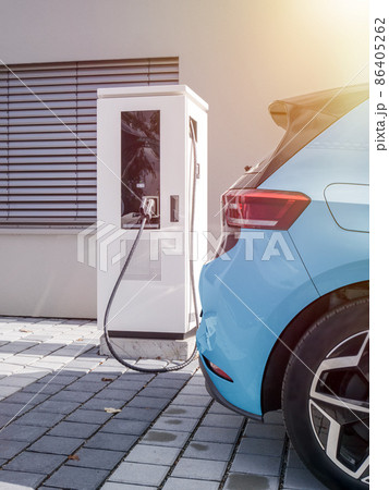 environment friendly electric car at charging station 86405262