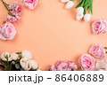 Colorful decorations t with spring flowers on orange background. copy space, top view 86406889
