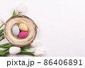 Colorful decorations with Easter egg nest and tulips on white background. copy space, top view 86406891