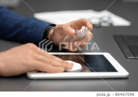 Unrecognizable man in suit cleaning digital tablet screen Unrecognizable man in suit cleaning digital tablet screen 86407096