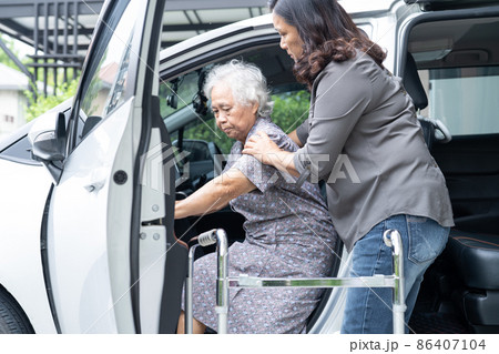 Help and support asian senior or elderly old lady woman patient walk with walker prepare get to her car, healthy strong medical concept. Help and support asian senior or elderly old lady woman patient walk with walker prepare get to her car, healthy strong medical concept. 86407104