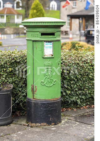 Traditional green letterbox, standing in the street Traditional green letterbox, standing in the street 86409604