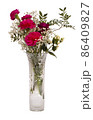 Red carnations and red rose bouquet in crystal vase 86409827