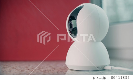 Modern indoor home security camera in action, close-up shot Modern indoor home security camera in action, close-up shot 86411332