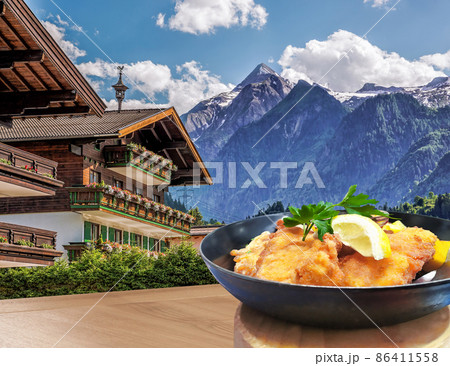 Kaprun village with hotel against Kitzsteinhorn glacier and with typical food(Schnitzel) in Salzburg region, Austrian Alps, Austria 86411558