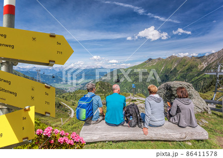 Tourists are watching the lake among Austrian Alps and cable cars in Zell am See-Kaprun region, Austria 86411578