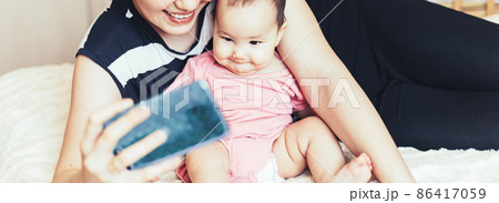 young mother is making selfie with her adorable little baby girl 86417059