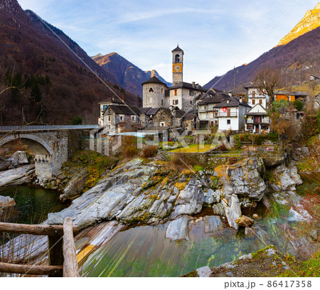 Alpine village of Lavertezzo on rocky slopes of mountain river Verzasca in winter, Switzerland Alpine village of Lavertezzo on rocky slopes of mountain river Verzasca in winter, Switzerland 86417358