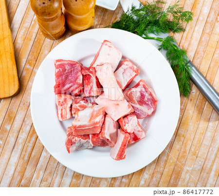 Pieces of uncooked pork ribs on table Pieces of uncooked pork ribs on table 86417772