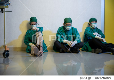 Tired doctor, Group of surgery doctors sadness fatigue after surgery 86420809