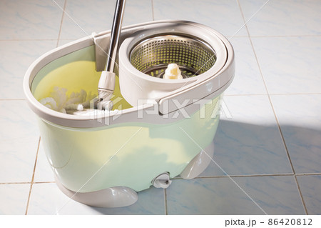 Mop with microfiber head spinning on the bucket Mop with microfiber head spinning on the bucket 86420812