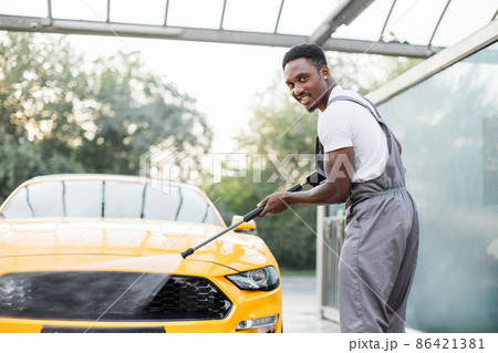 Manual car wash with pressurized water in car wash outside. Manual car wash with pressurized water in car wash outside. 86421381