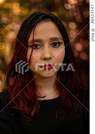 Young caucasian dark haired girl with red streaks in black dress outfit 86423547