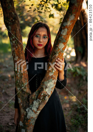 Young caucasian dark haired girl with red streaks in black dress outfit 86423550