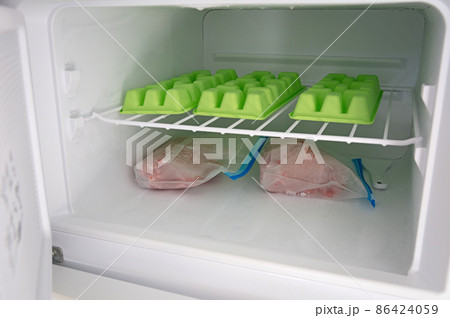 Raw minced meat of  beef in plastic bags in the freezer 86424059