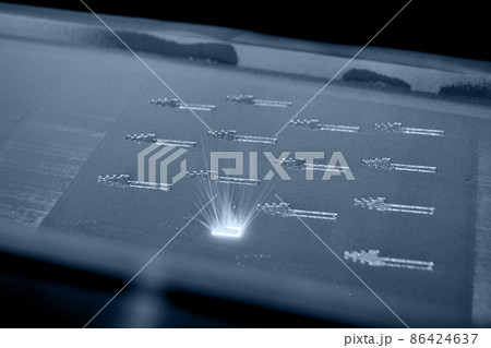 3D printer prints object from metal powder. Metal is sintered under laser 3D printer prints object from metal powder. Metal is sintered under laser 86424637