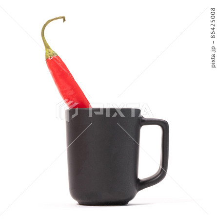 Red hot chili peppers in small coffee mug, isolated Red hot chili peppers in small coffee mug, isolated 86425008