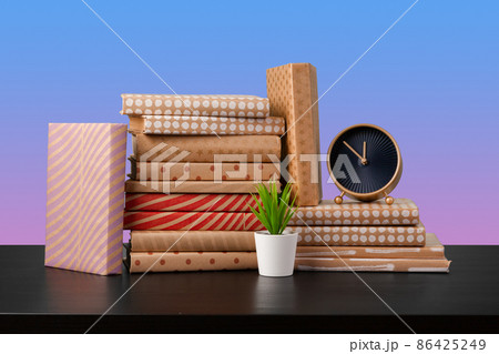 Stack of books on black wooden table Stack of books on black wooden table 86425249