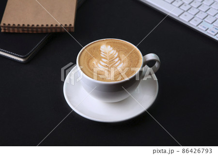 Cup of coffee and a notepad for notes.Computer keyboard and mouse.Top view.Business breakfast.Food and drinks.Coffee break. Space for copying.Flat position.Black background. 86426793