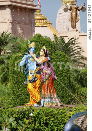 Radha and Krishna playing the flute in garden of Nilkanthdham, Swaminarayan temple, Poicha, Gujarat, India Radha and Krishna playing the flute in garden of Nilkanthdham, Swaminarayan temple, Poicha, Gujarat, India 86427642