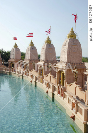 Sandstone mandapas around the artificial lake at Neelkanth Dham Swaminarayan Temple, Poicha, Gujarat, India, located at Poicha, Gujarat, India 86427687