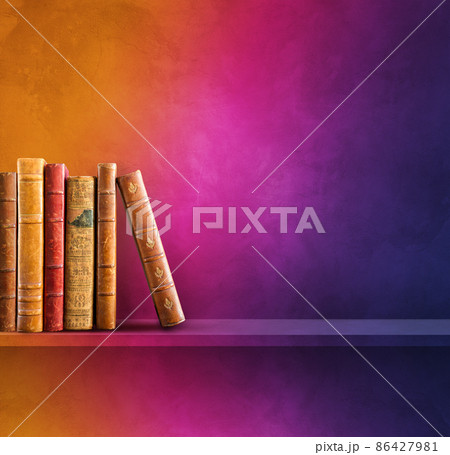Row of old books on rainbow shelf. Square background 86427981